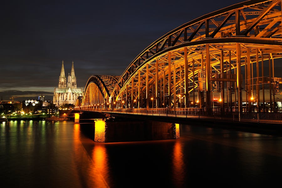 Cologne by night, with the river Rhine in the foreground and the famous Cologne Cathedral in the background